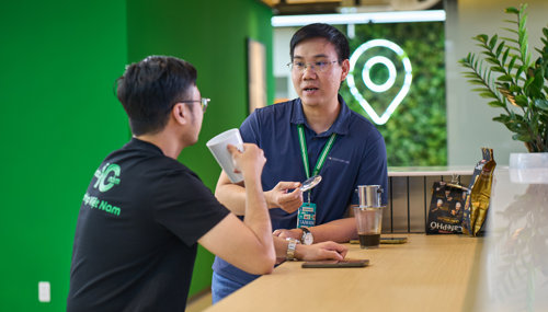 a person talking to another person at a bar