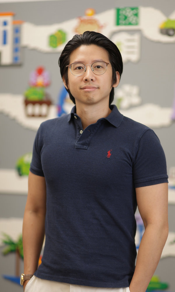 a man wearing glasses and a blue polo shirt
