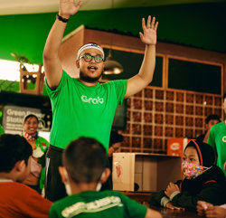 a man in a green shirt raising his hands