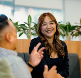 a person sitting in a chair and smiling