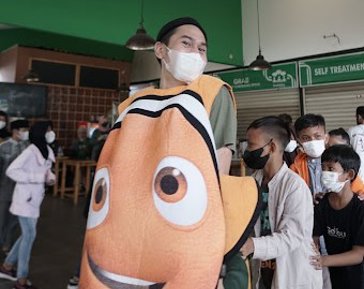 a man wearing a mask and holding a garment