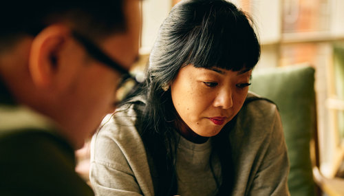 a woman looking at a man