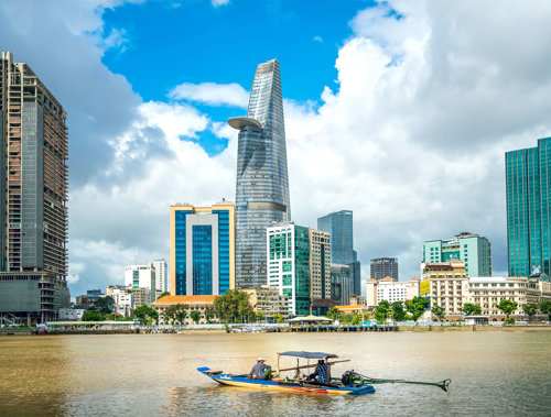 a boat in a body of water with a city in the background