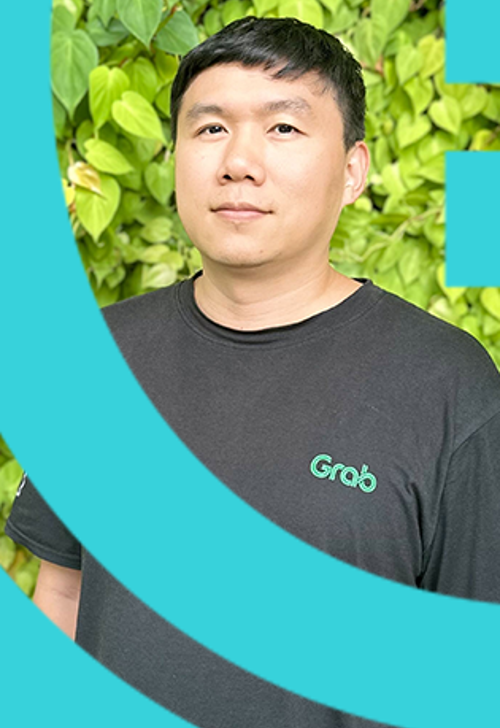 a person standing in front of a green bush