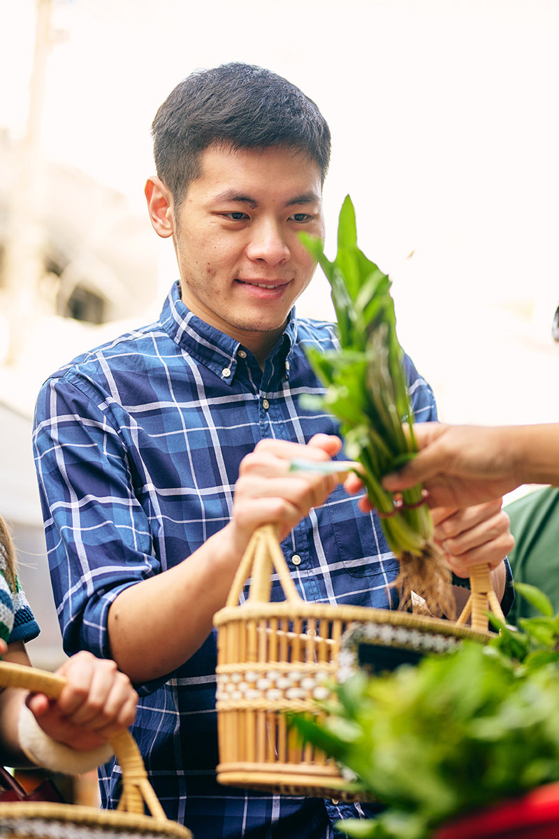 a group of people holding baskets with plants