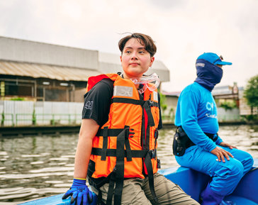 a person in a life jacket sitting on a boat