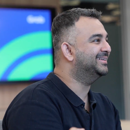 a person smiling and looking to the side