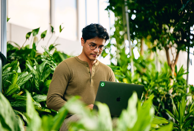a man sitting in front of a laptop