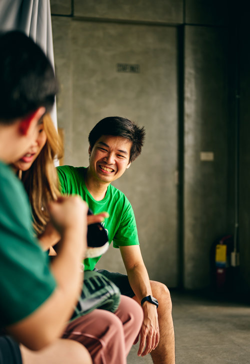 a person in a green shirt laughing