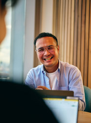 a man in glasses laughing