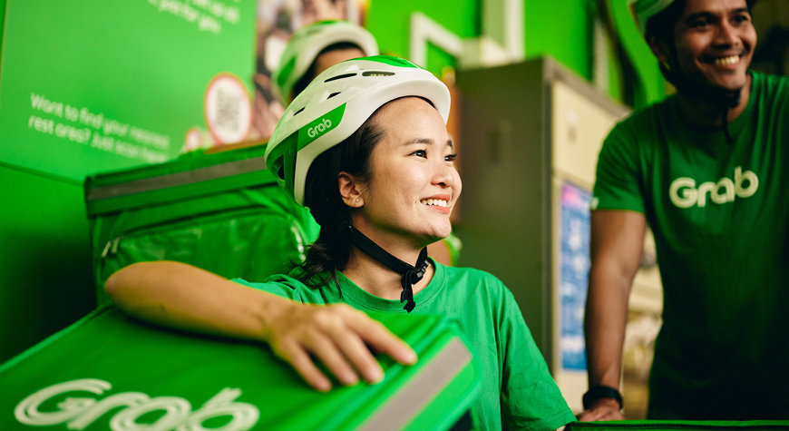 a woman wearing green shirts and white helmets