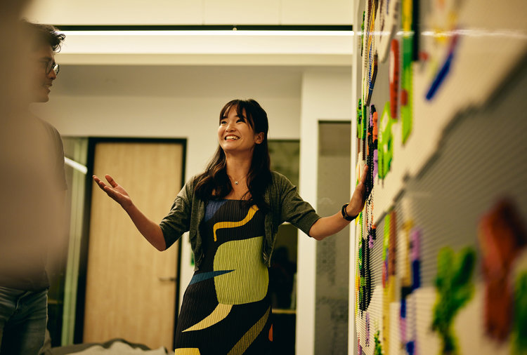a woman standing in front of a wall with magnets