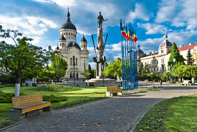 a park with a statue in the background