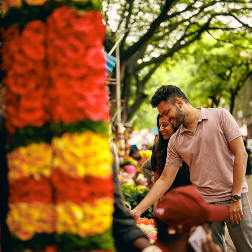 a man and woman standing next to a tree
