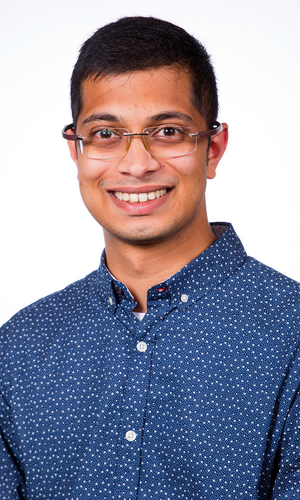 a man wearing glasses and a blue shirt