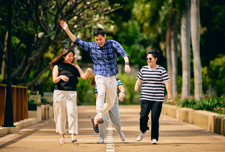 a group of people running on a sidewalk