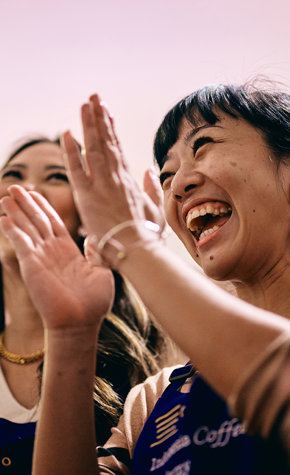 a group of women clapping their hands