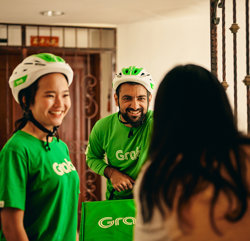 a group of people wearing green shirts and helmets