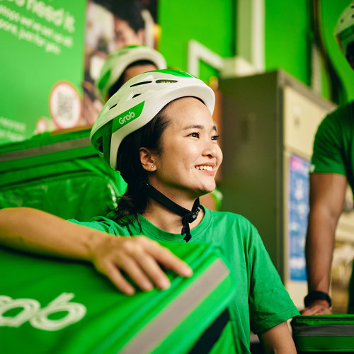 a woman wearing green shirts and white helmets