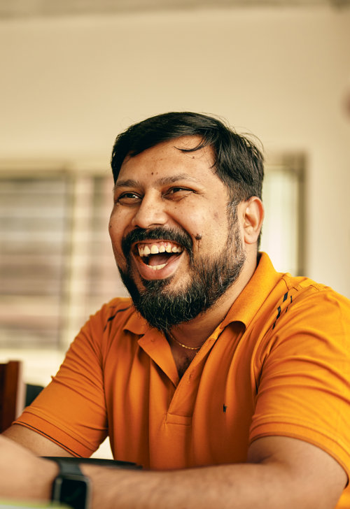 a person laughing with a beard
