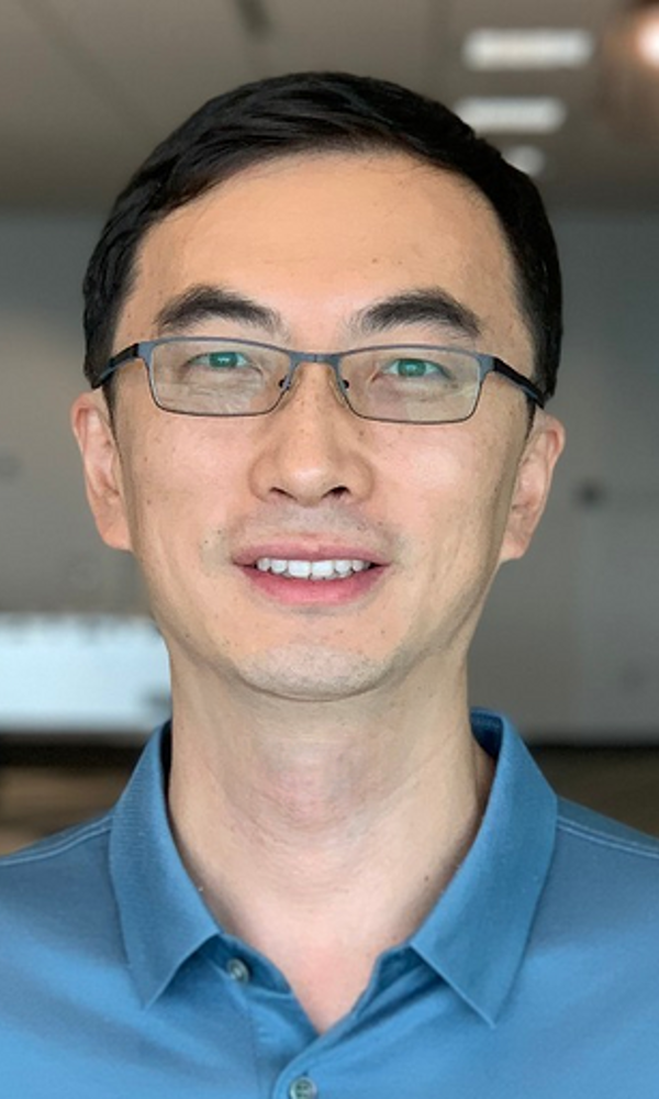 a man wearing glasses and a blue shirt