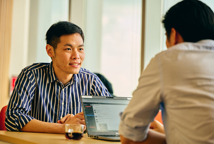 a man sitting at a table with a laptop