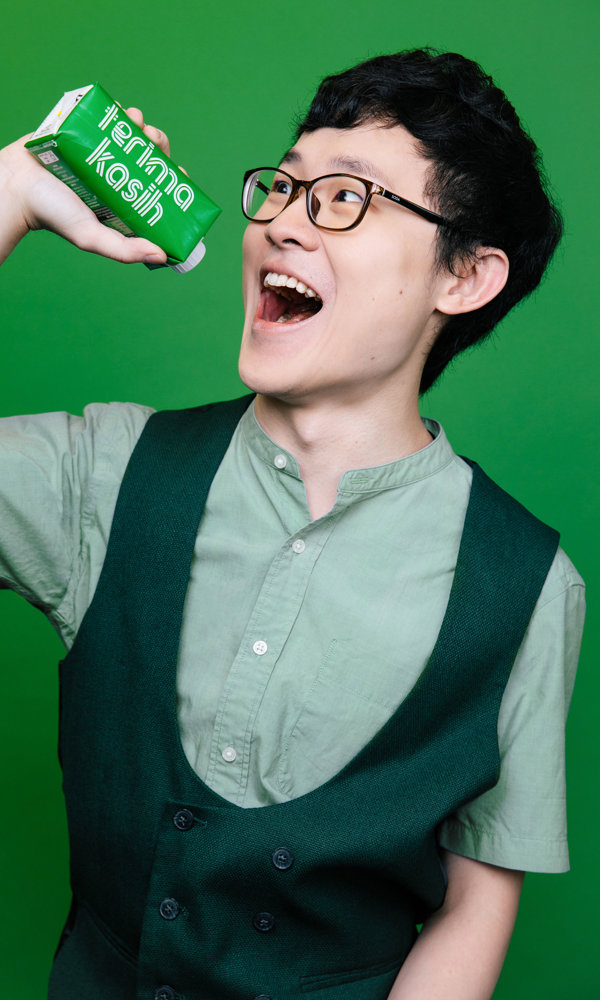 a man holding a green juice bottle