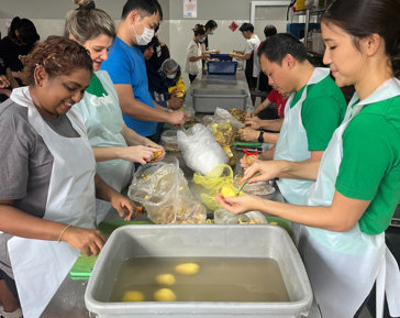 a group of people in aprons preparing food
