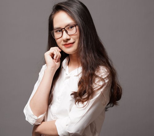 a woman with long hair wearing glasses