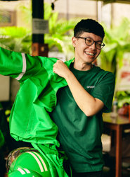 a man wearing green shirt and glasses