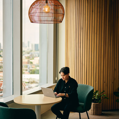 a man sitting at a table with a laptop
